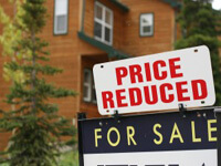 For Sale and Price Reduced Signs on a Home