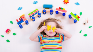 child in daycare with blocks and train