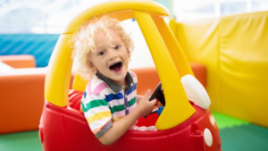 child in daycare in toy car