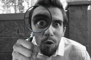 Home Inspector looking through a magnifying glass