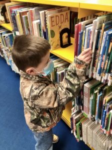boy looking at books at the Round Rock Public Library