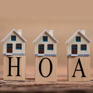 little homes stacked on blocks reading HOA